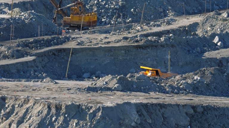 Open pit mine. Big yellow trucks transport ore in an asbestos mineral quarry.